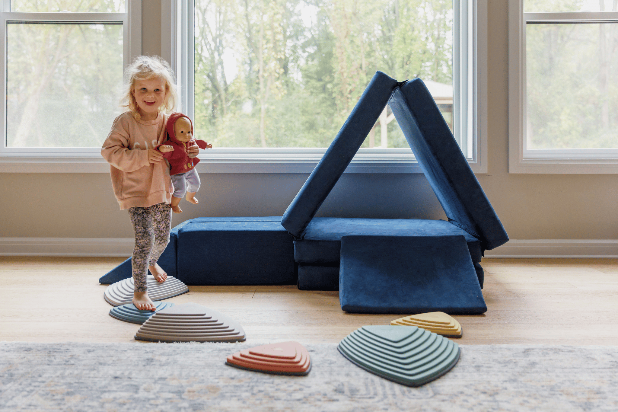 Child Making Play Couch into a Fort
