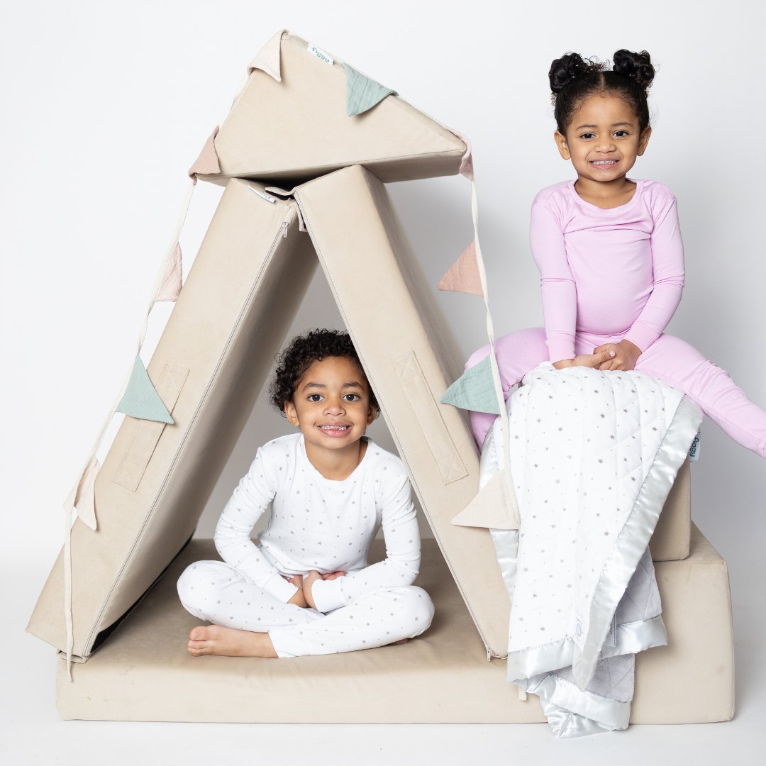 Kids building a fort with their Figgy play couch