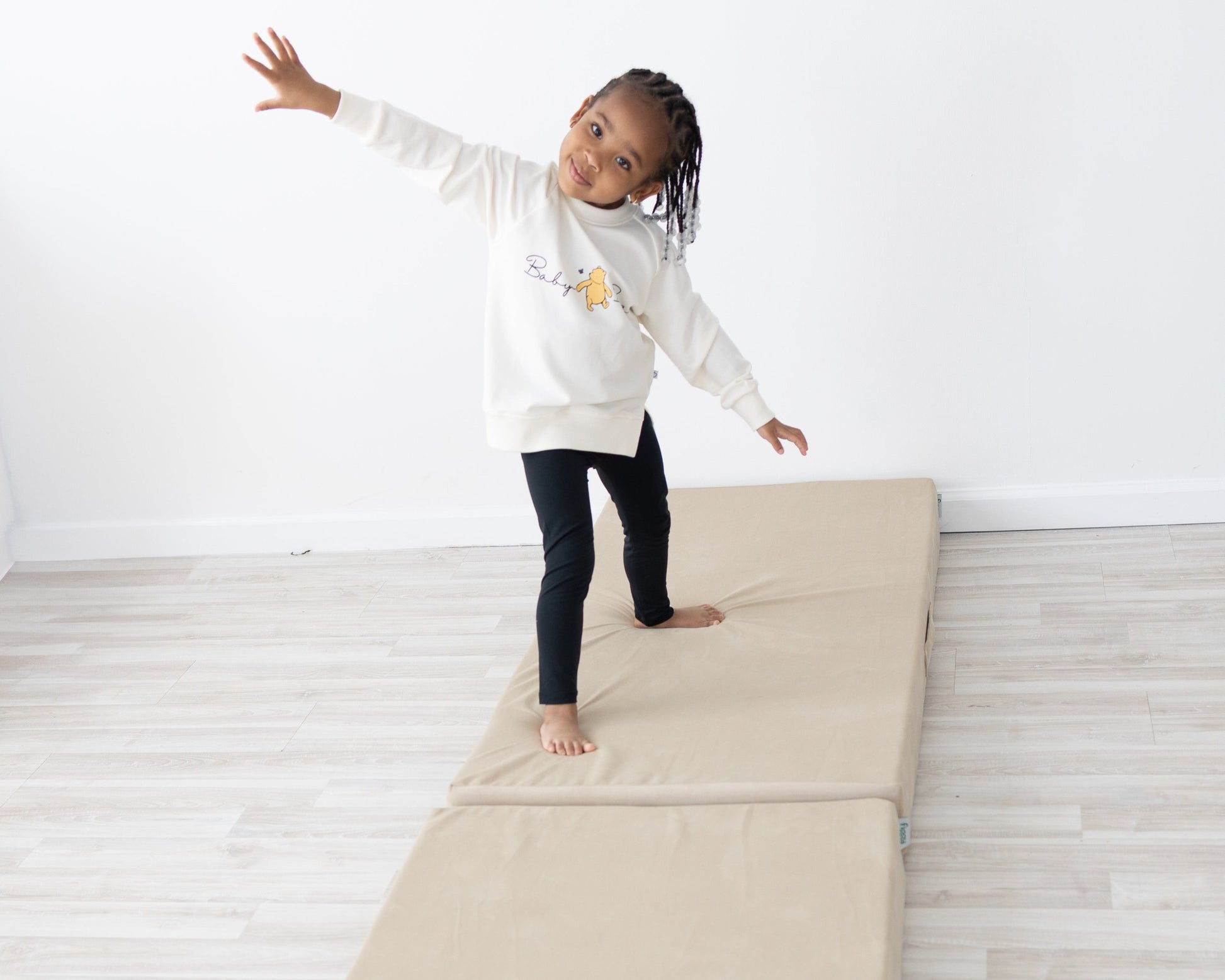 Girl playing on beige Figgy play mat