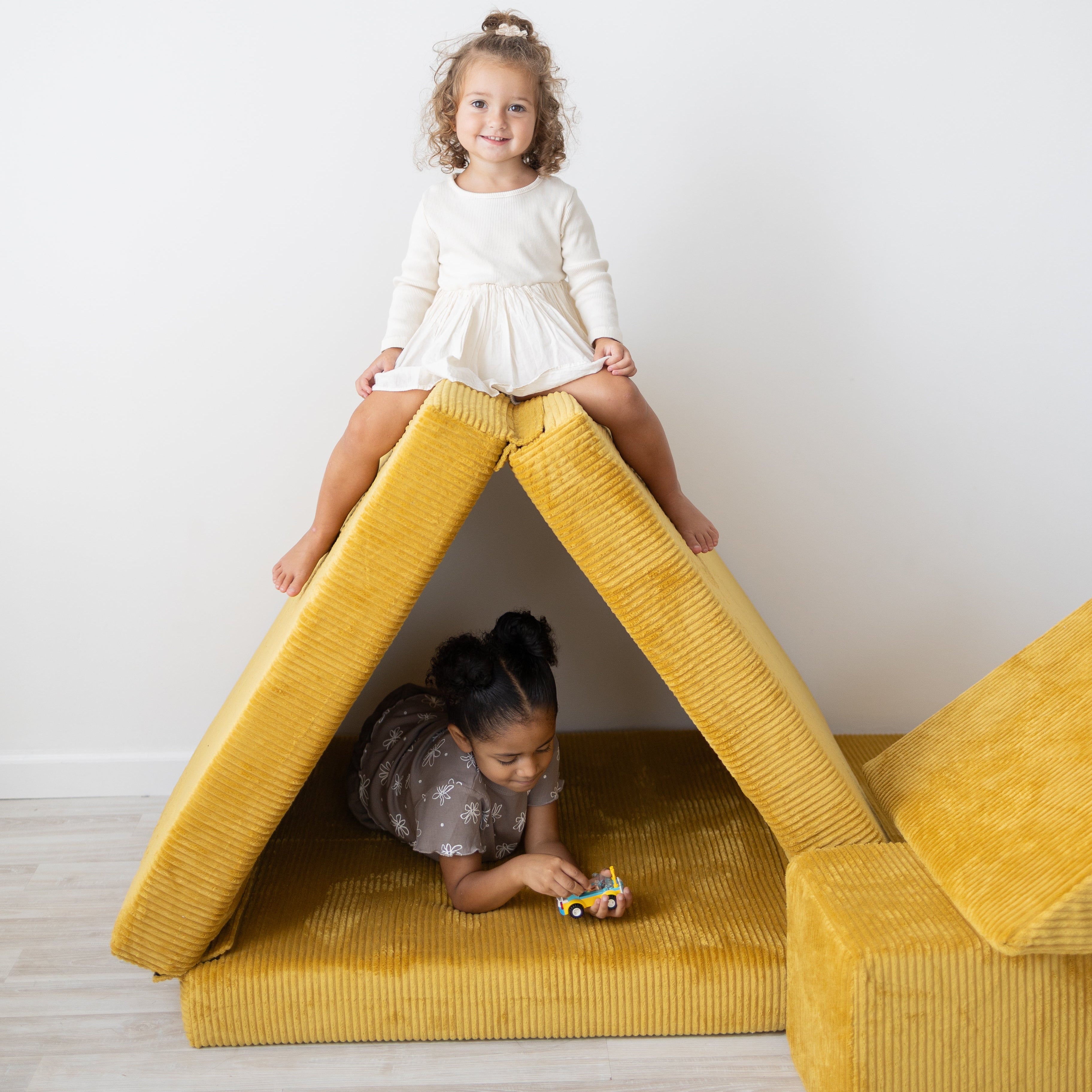 Girls playing in a Figgy fort
