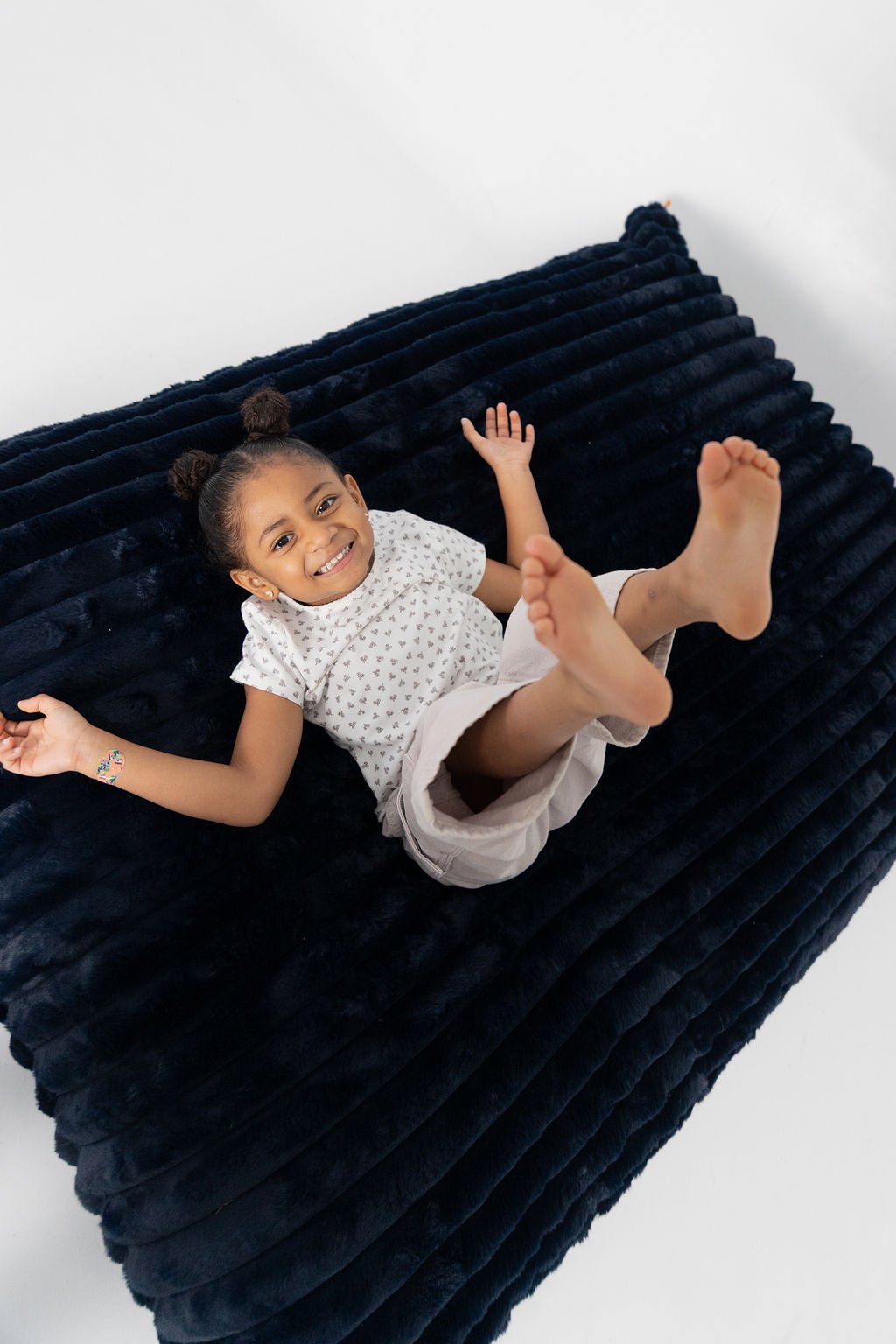 A girl sprawled on a Night Owl Baggy, seen from above