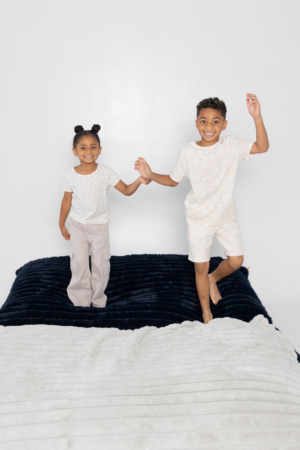 Two kids holding hands on a Night Owl Baggy