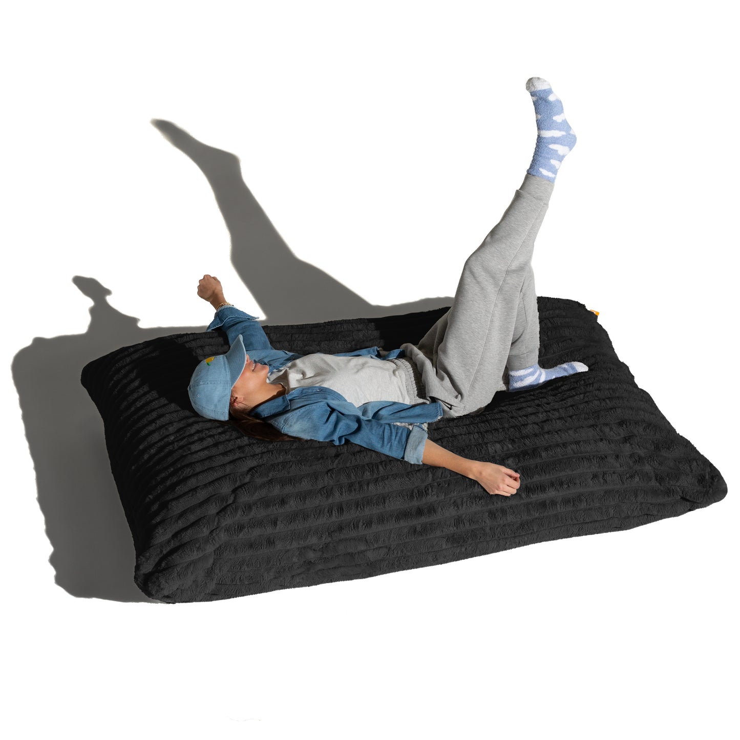 The Shadow Baggy shown flat with a person lying across it, for scale