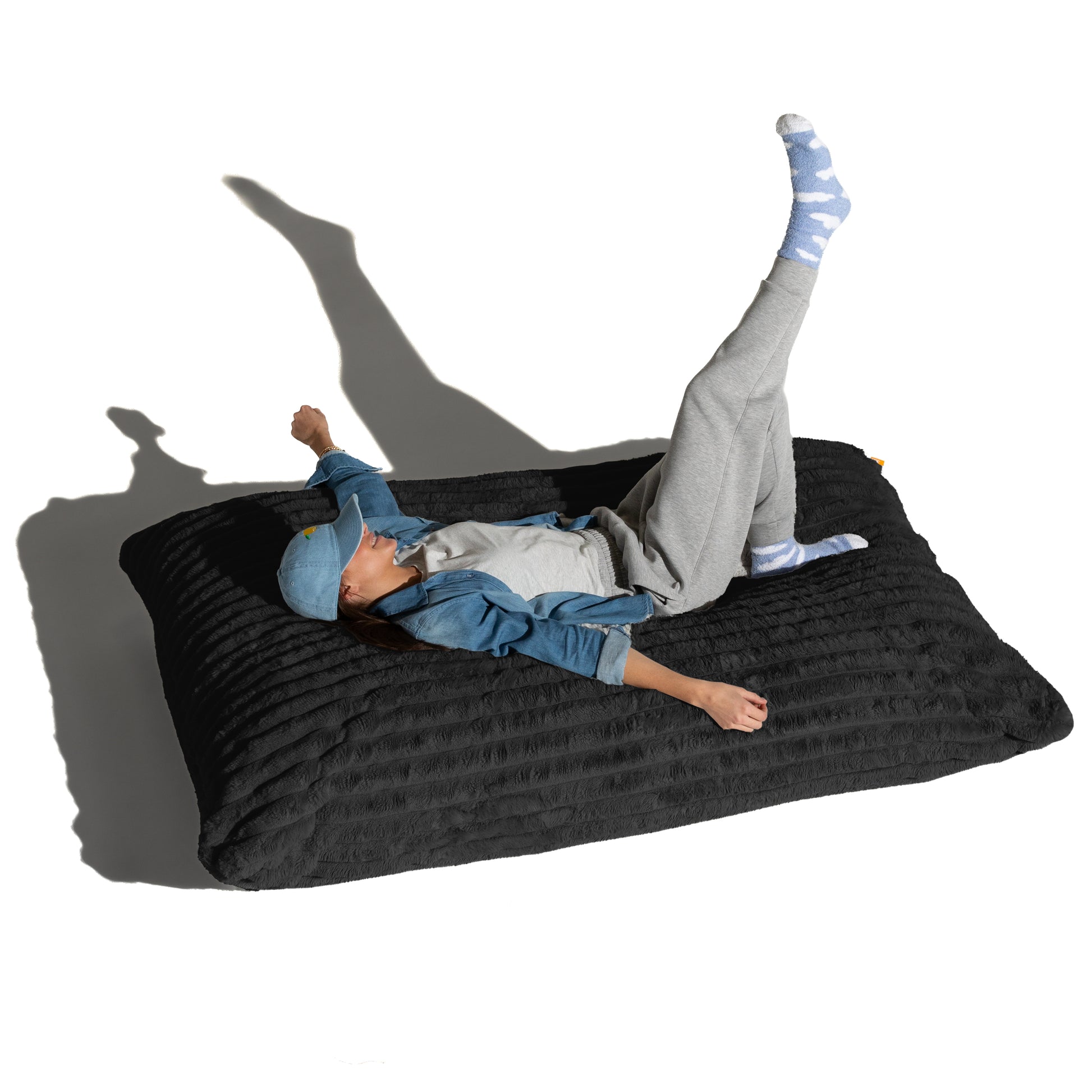 The Shadow Baggy shown flat with a person lying across it, for scale