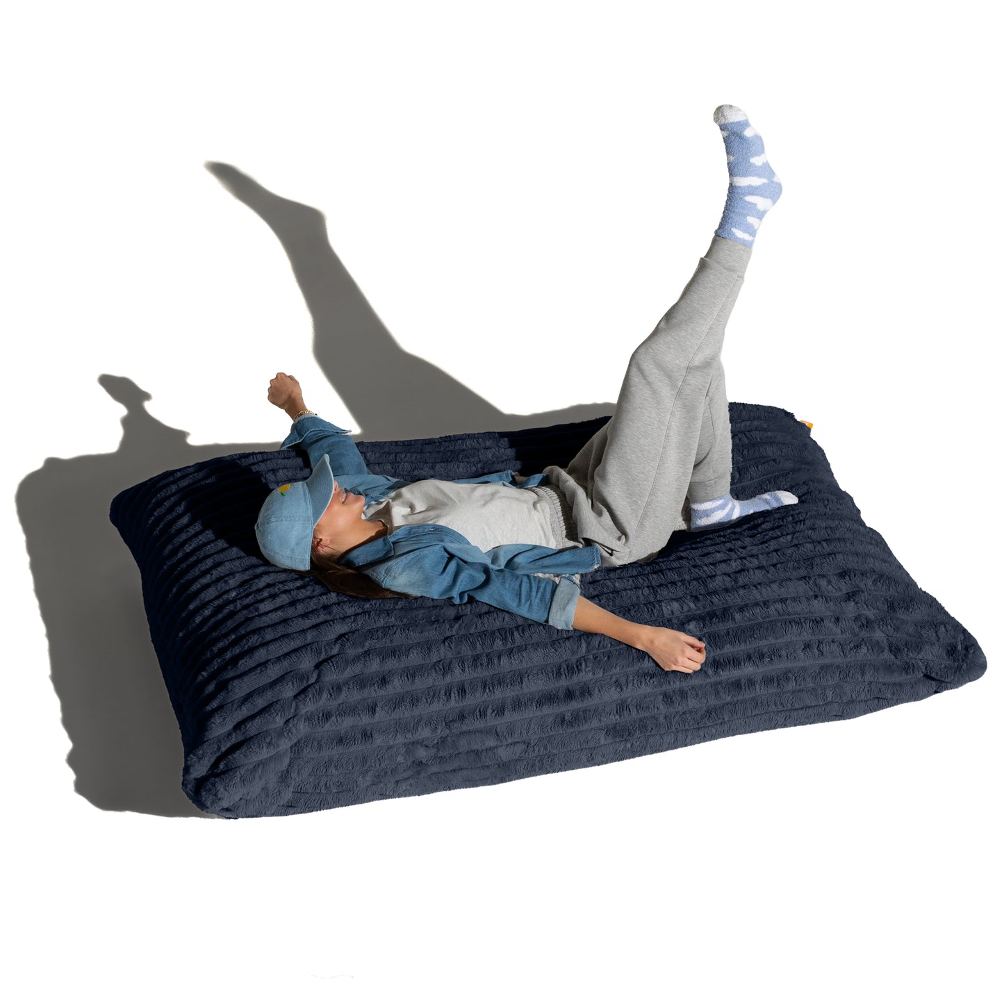 The Night Owl Baggy shown flat with a person lying across it, for scale