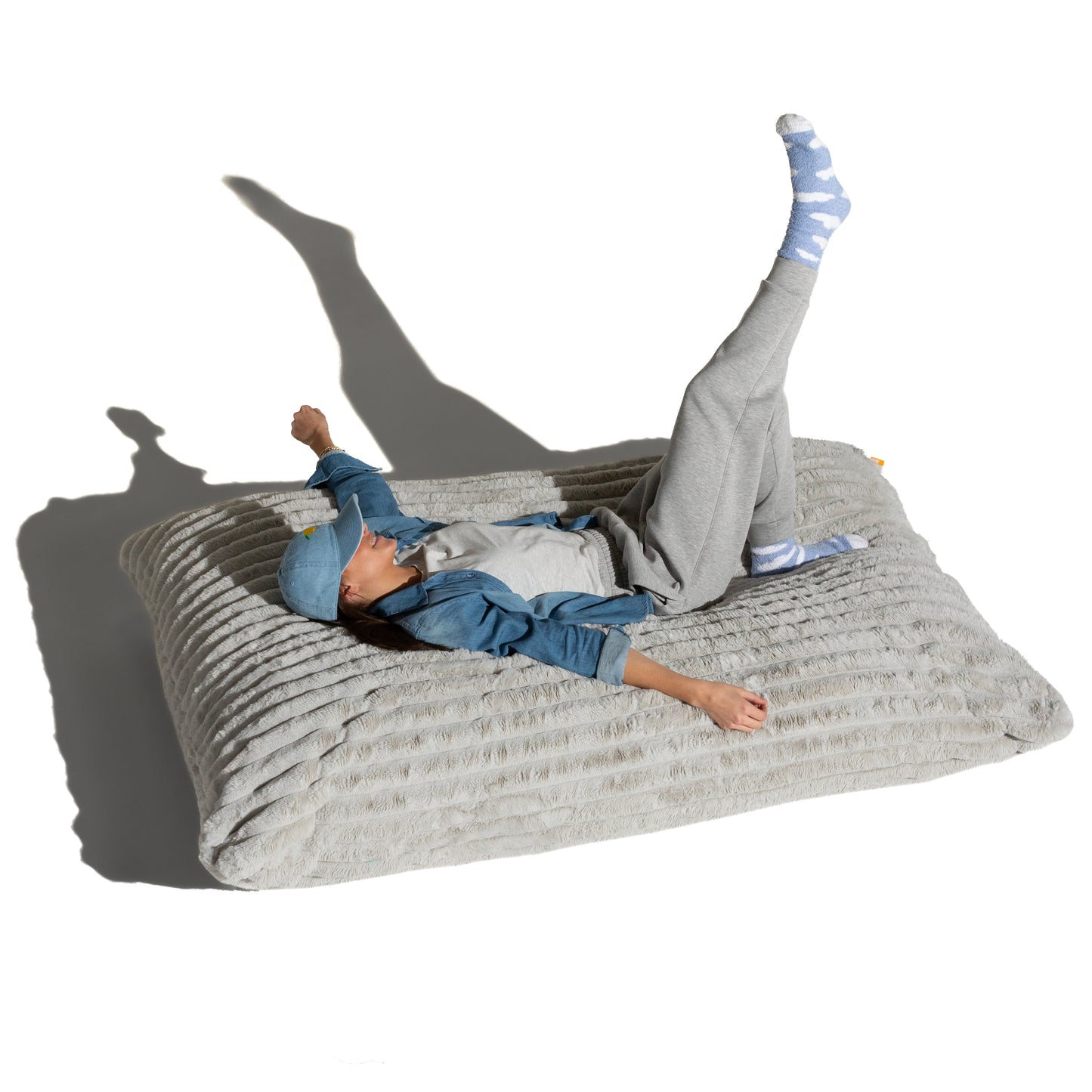 The Birdsnest Baggy shown flat with a person lying across it, for scale