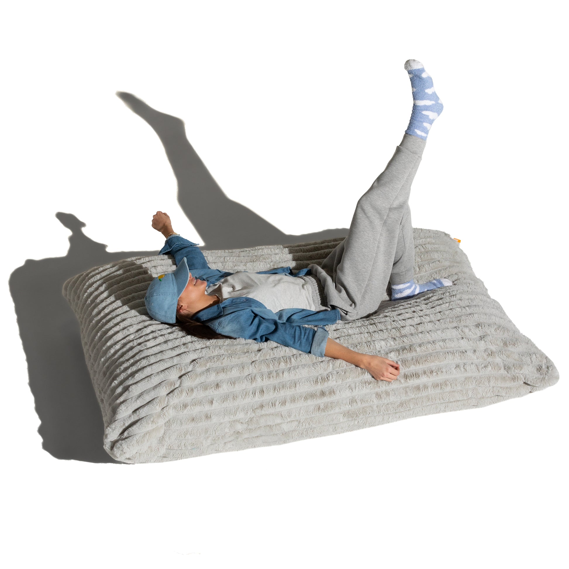 The Birdsnest Baggy shown flat with a person lying across it, for scale