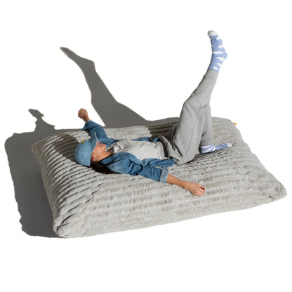 The Birdsnest Baggy shown flat with a person lying across it, for scale