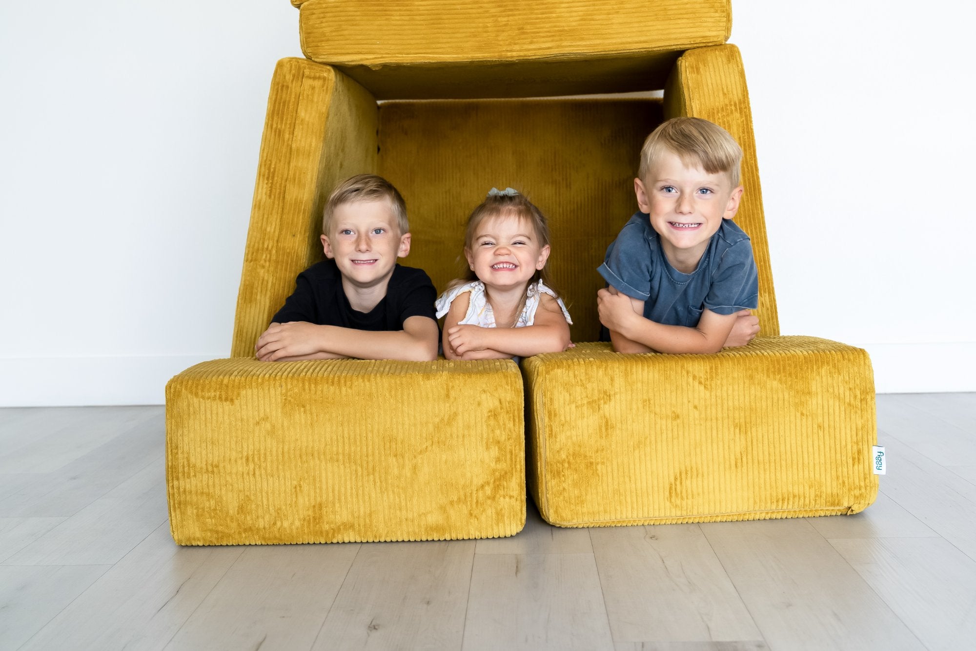 Kids building a fort with the Figgy Play Couch